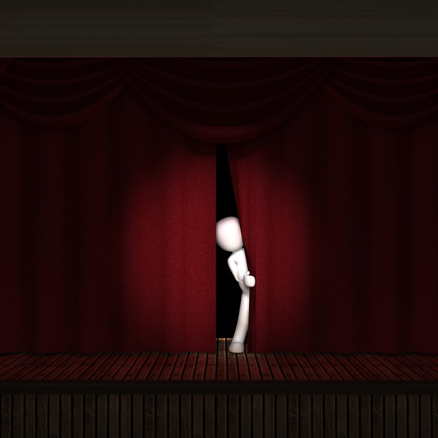 figure peering out from behind curtain
