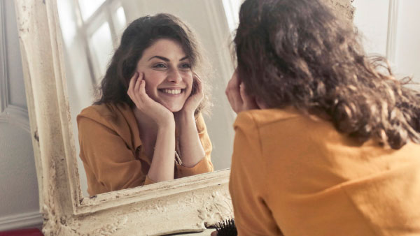 Woman staring at herself in mirror