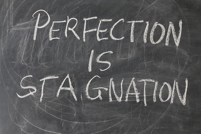 "Perfection is Stagnation" written on chalkboard