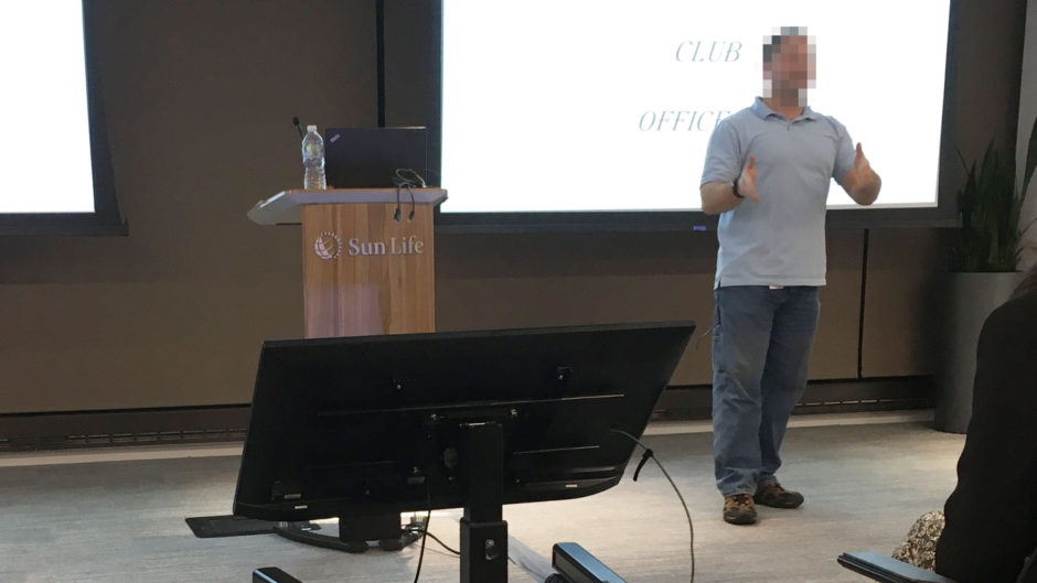 Photo of a man presenting with large confidence monitor