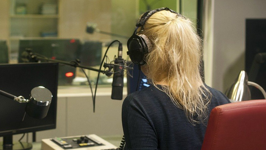 Photo of a femail DJ at a radio station