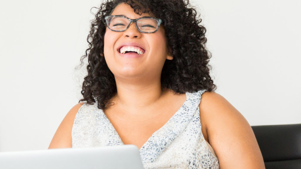 Photo of laughing woman at laptop