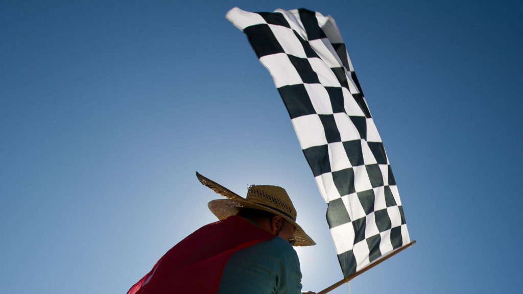 Person waving a checkered flag