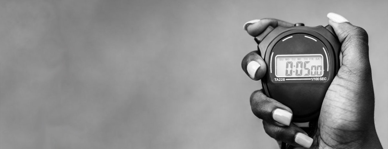 Photo of woman's hand holding a digital stopwatch