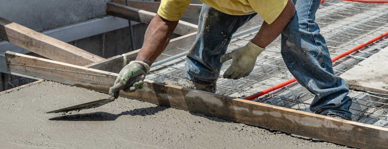 Photo of worker smoothing concrete with a trowel
