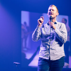 Man speaking from a stage
